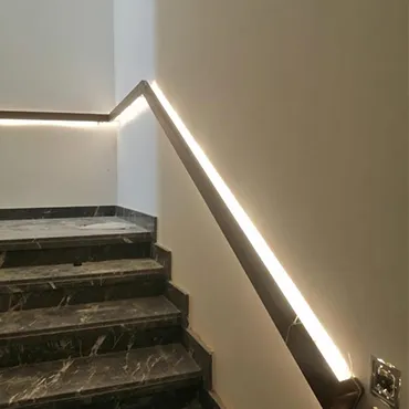 Interior stair with concealed linear lighting integrated into the wall